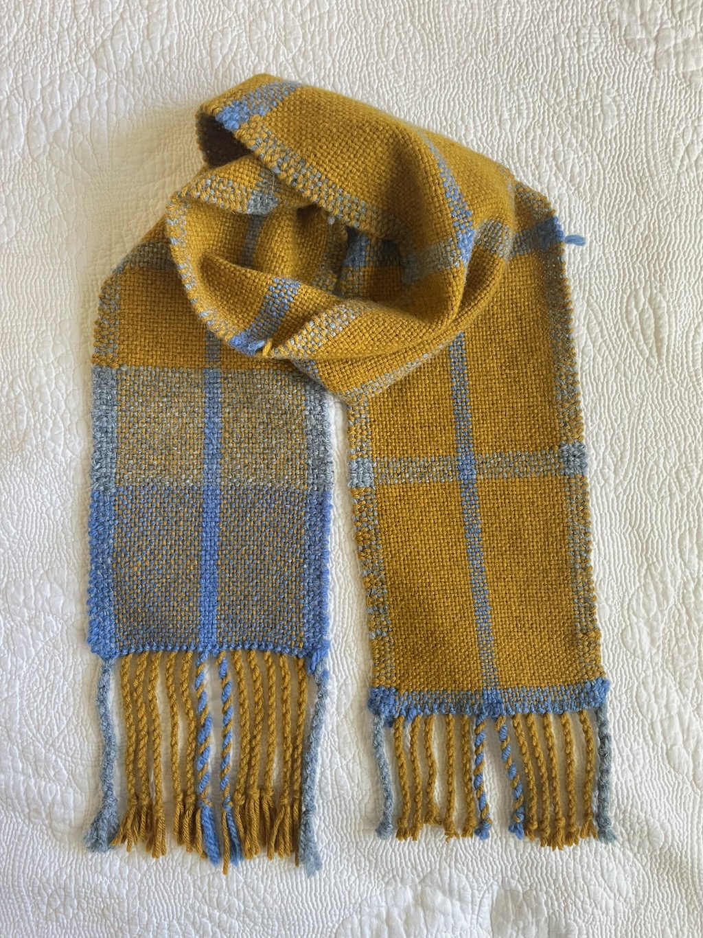Mustard scarf folded into a loop